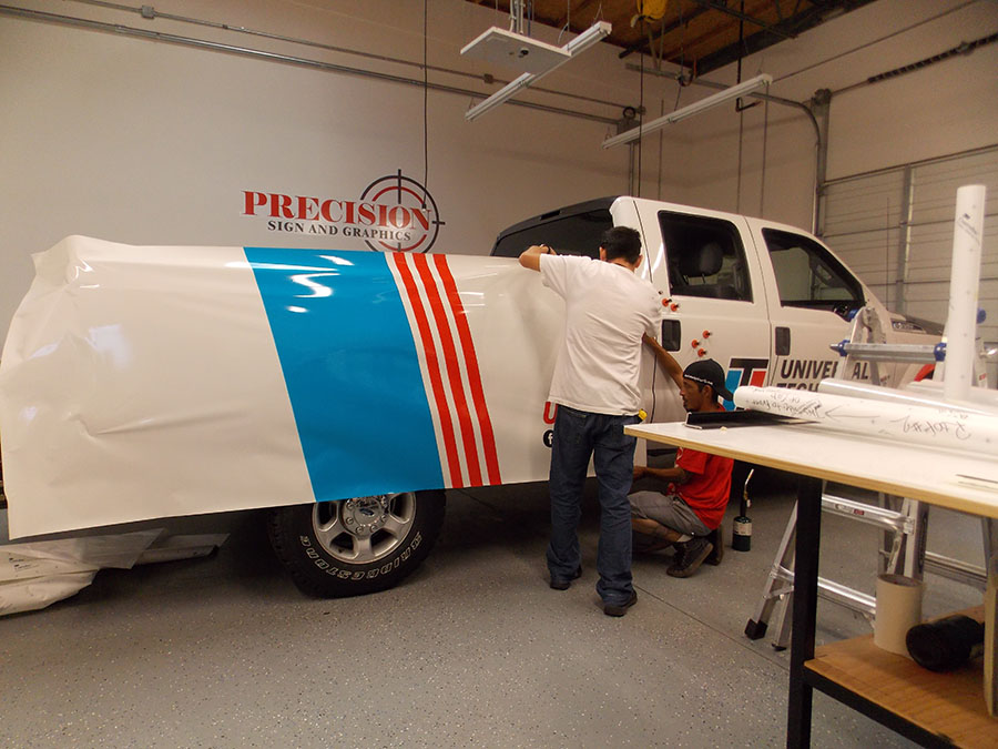 Trained professional applying a wrap - Vehicle Wraps in Fontana, Rancho, Jurupa, Riverside and Eastvale